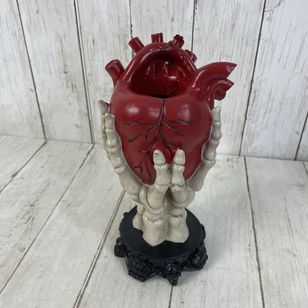 Ashland Halloween Red Anatomical Heat in Skeleton Hands Statue Decor